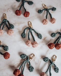 several different colored rope and metal objects on a white counter top with gold clasps