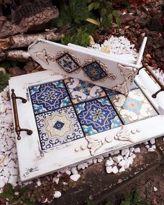 an old window has been decorated with blue and white mosaic tiles on the outside wall