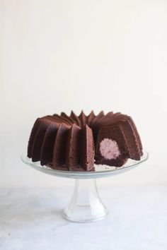 a chocolate bundt cake on a glass plate