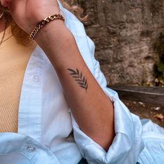 a woman with a tattoo on her arm