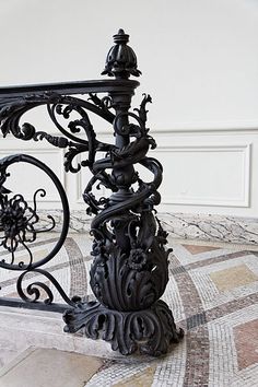 an ornate wrought iron railing on the ground