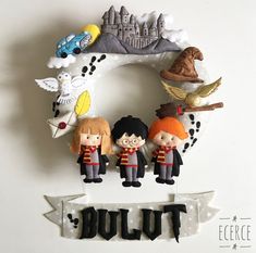 a harry potter wreath with three dolls hanging from it's side and the words built above it