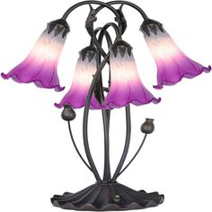 three pink and white glass flowers on a black metal stand with an ornate design in the center