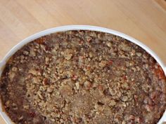 a casserole dish filled with food on top of a wooden table