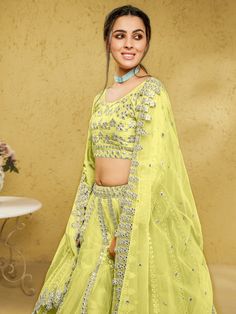 Introducing our captivating lime yellow foil work net engagement wear lehenga choli, a stunning ensemble that will make you the center of attention at any special occasion. This exquisite outfit features a lime yellow color net material lehenga with intricate foil work, complemented by a similar color net material choli also adorned with foil work. Complete your look with the included matching net dupatta, which features both foil work and beautiful lace work.
The lime yellow lehenga is semi-sti Yellow Organza Sets For Navratri, Green Net Sets With Dupatta, Green Semi-stitched Net Lehenga, Yellow Organza Sets With Dori Work, Green Net Semi-stitched Lehenga, Bollywood Style Green Net Lehenga, Green Net Diwali Set, Festive Green Net Lehenga, Green Net Choli With Zari Work