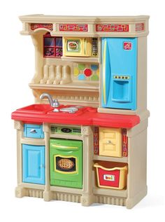 a toy kitchen with an oven, sink and stove top on display in front of a white background