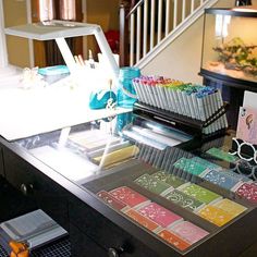 a desk with many different colored cards and pens on it next to a stair case