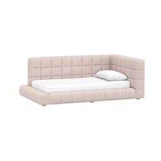 a pink couch with pillows on it and a pillow in the middle of the couch