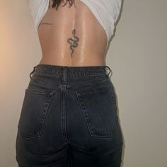 the back of a woman with tattoos on her stomach