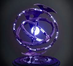 a purple light up sculpture on top of a black surface with an arrow in the center