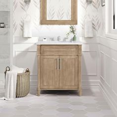 a bathroom with a sink, mirror and towel rack in it's center area