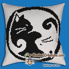 a black and white cat pillow with the word hooked creations written in front of it