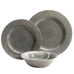 a set of gray dinnerware with silver rims