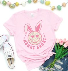 Hunny Bunny Retro Leopard Smiley Face Bunny Tee #customeastershirt #cuteeastershirts #easterbunnyshirt #eastershirts #eastersundayshirt #familyeastershirt #familymatchingtee #giftforeaster #kidsnames #grandchildrennames #grandmagift #nanagift #happyeastershirt #kidseastershirts #monogram #personalizedeaster #personalizedgift #shirtforgrandma #shirtforwomen #shirtfornana #shirtforgigi #shirtforteacher #shirtforlunchlady #shirtforbusdriver Easter Teacher Gifts, Funny Easter Shirt, Kids Easter Shirts, Hunny Bunny, Easter Tees, Easter Bunny Shirts, Easter T Shirts, Honey Bunny, Bunny Shirt