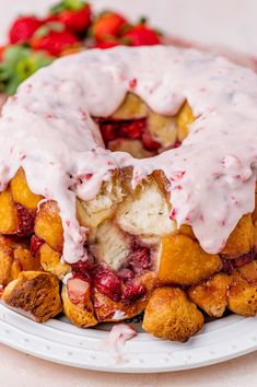 a strawberry bundt cake with icing on a plate