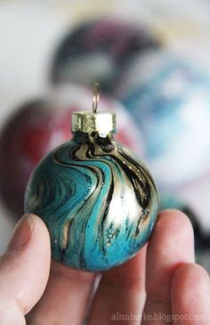 a hand holding an ornament that looks like marble