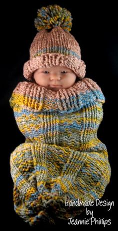 a baby wearing a knitted hat and scarf