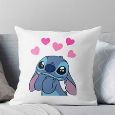 a cartoon character with hearts on his head and eyes, sitting on a couch throw pillow