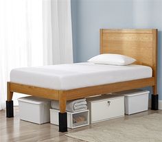 a bed that has some drawers underneath it