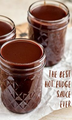 three jars filled with homemade hot fudge sauce sitting on top of wax paper and the words, the best homemade hot fudge sauce in the world