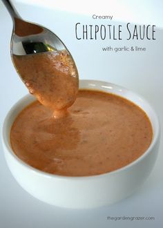 a spoon full of sauce being poured into a white bowl with the words creamy chipote sauce on it