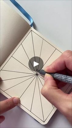 someone is drawing an image on a piece of paper