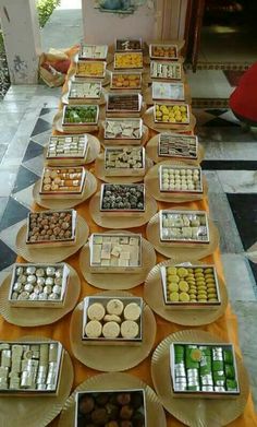 a table topped with lots of trays filled with different types of desserts and pastries