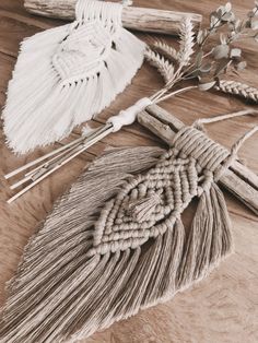 two tassels are tied together on a wooden table with other items around them