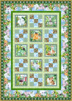 a green quilt with animals and flowers on the border, in front of a blue sky