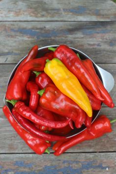 red and yellow peppers in a metal bowl