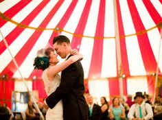 a bride and groom dance in front of an audience