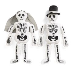 two stuffed skeletons are standing next to each other, one is wearing a top hat