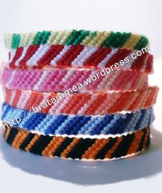 multicolored woven bracelets stacked on top of each other