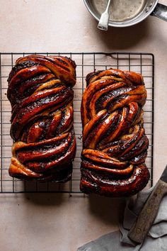 two loaves of bread sitting on top of a cooling rack