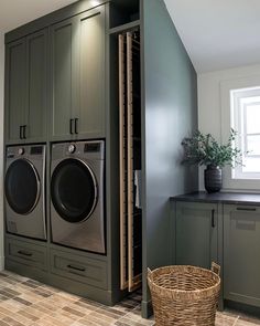 a washer and dryer in a laundry room next to cabinets with doors open