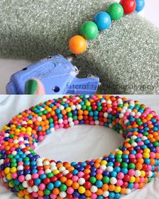 a toy train is next to a colorful beaded wreath on a pillow and another photo has a blue truck in the background