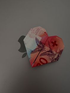 an origami heart made out of money