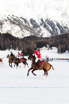 several people are riding horses in the snow