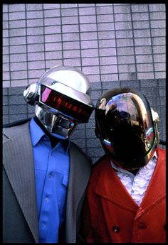 two mannequins dressed in suits and helmets are standing next to each other