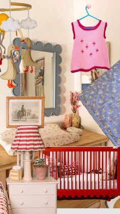 a baby's room is decorated in pink, blue and white