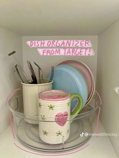 the dish organizer is organized with cups and plates