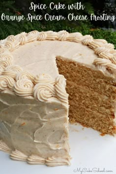 an orange cake with cream cheese frosting is cut into slices and sits on a white plate