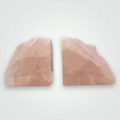 two pieces of pink rock sitting next to each other