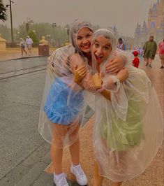 two women hugging each other on the street