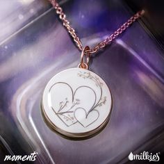 two hearts in the middle of a necklace on a purple background with words written below it