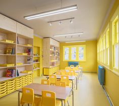 an empty school room with yellow chairs and bookshelves