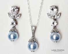 Wedding Light Blue Blush Baby Blue Colored Pearl Cubic Zirconia Silver Dainty Bridal Earrings and Necklace Jewelry Set with .925 Sterling Silver Chain. EARRINGS are 1.06 inch (2.7cm) long from top of erring stud to bottom. CHAIN is 18 inches (45.7cm) long. PENDANT is about 0.82 inch (2.1cm) including bail. Elegant and timeless, these dainty jewelry set is perfect for weddings or special occasions such as birthdays, anniversaries, graduations, proms...or whatever you can imagine! Handmade jewelry Blue Wedding Jewelry With Matching Earrings, Blue Dangle Necklaces For Wedding, Blue Round Jewelry Sets For Wedding, Blue Pearl Drop Jewelry For Wedding, Blue Pearl Drop Wedding Jewelry, Blue Pearl Drop Necklaces For Wedding, Blue Pearl Drop Necklace For Wedding, Light Blue Teardrop Jewelry For Wedding, Blue Pearl Drop Bridal Earrings For Wedding