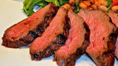 some meat and vegetables on a white plate