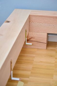 a wooden desk with two metal handles on the top and one has a hole in it