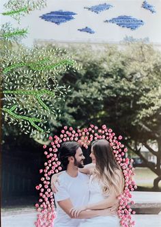 two people sitting on a bench with flowers in front of them